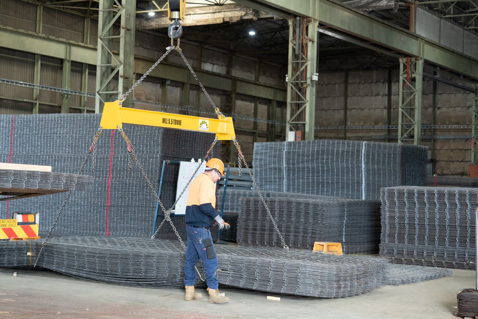 Mesh sheets being moved by crane