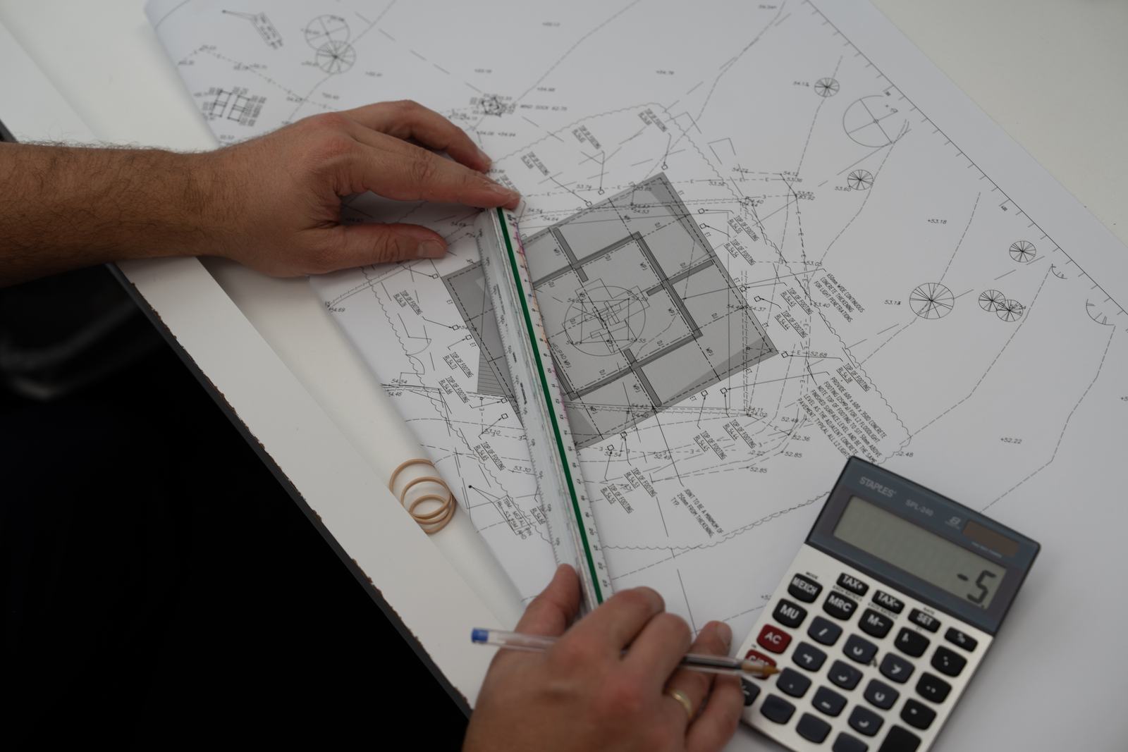Estimator measuring structural drawings with a scale ruler